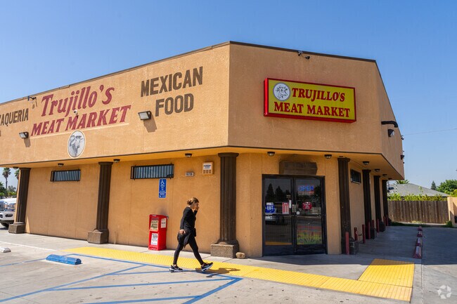People arrive at Trujillo's Meat Market in North Madera to shop for groceries.