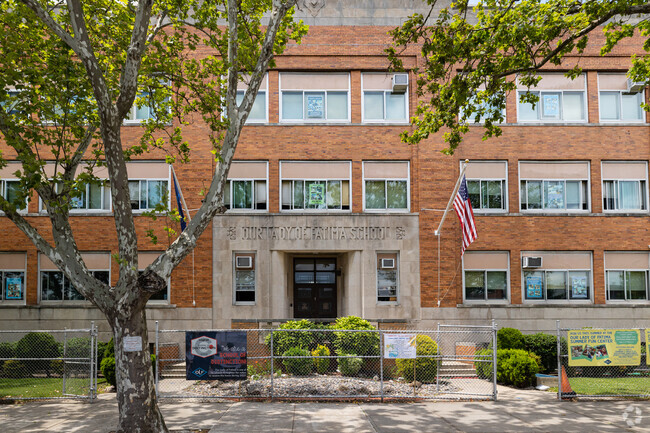 Our Lady of Fatima School in Queens, New York has a beautiful entrance framed by trees.