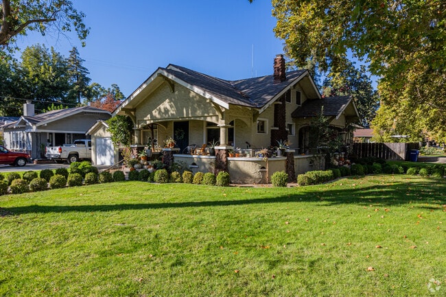 A cross gabbled craftsman style home with a hatched chimney in Auora.