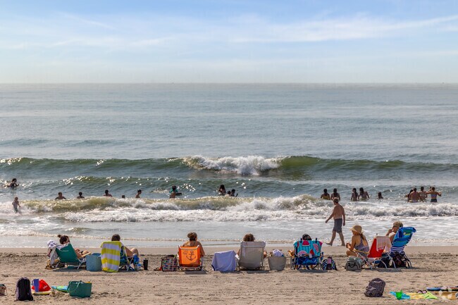 Parents watch children swim in the Atlantic from the shoreline at Sea Isle City.