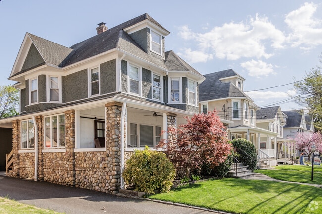 Craftsman and American Foursquare style homes line a street in Madison, NJ.