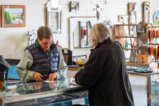 A visitor buys handcrafted jewelry at Cibola Arts Gallery in Mountainair.