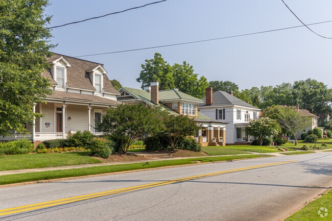 A row of craftsman style homes with various additions can be found throughout Barnesville, GA.