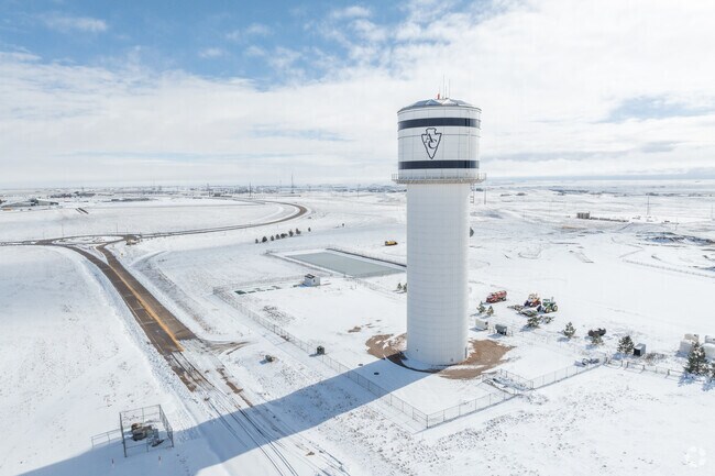 A large water tower is seen in the hilly terrain of HR Ranch.