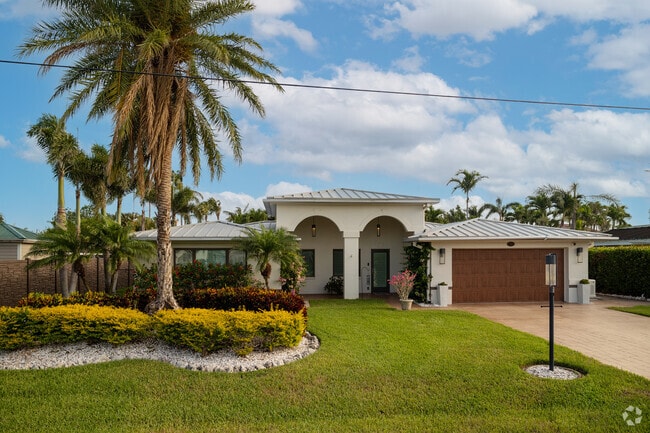 Lush landscaping and palm trees help homes in the neighborhood stand out.