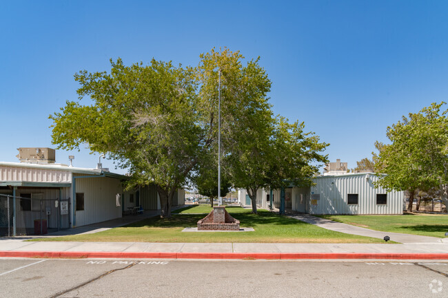 The Flag pole is center to the entrance at Mesquite High School.