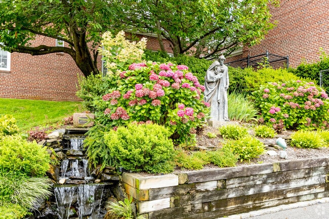 Statues and a waterfall adorn the grounds of Our Lady of Wisdom Regional School.