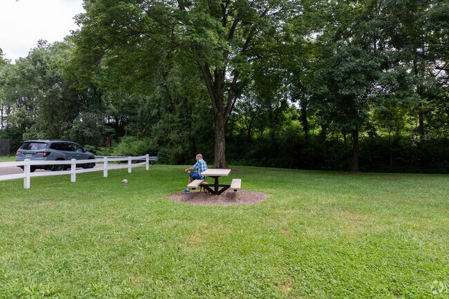 A resident of Sugarcreek relaxes with his dog at Cherry Ridge Park.