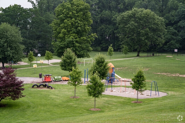 Hillside Elementary School's playground sits in a natural, green setting.