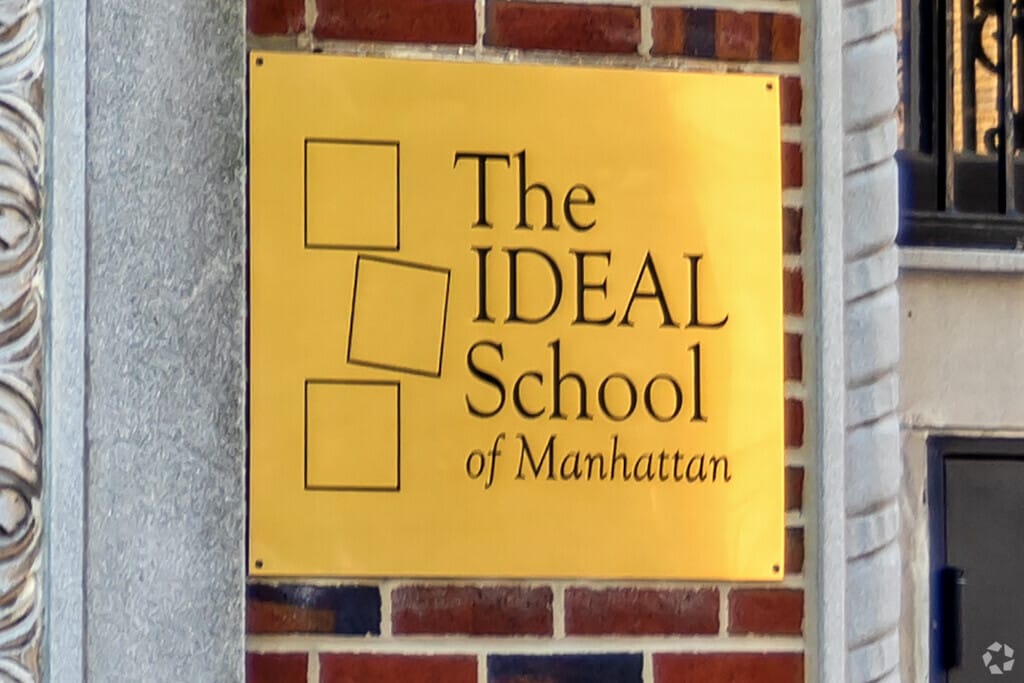 The Ideal School Of Manhattan's sign stands out amongst the brick, inviting students in.