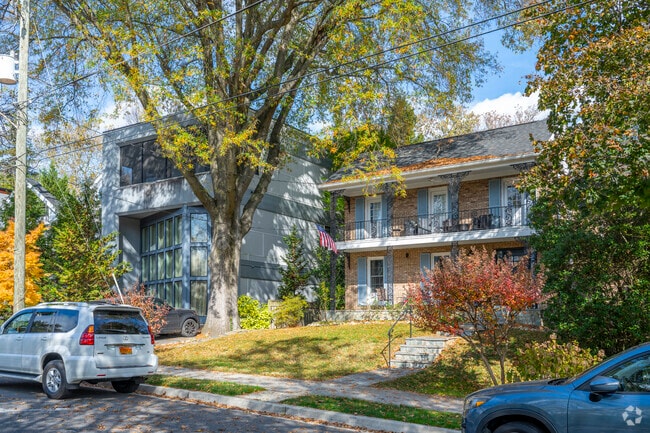 A modern style home next to a French Colonial style home in Spring Valley.