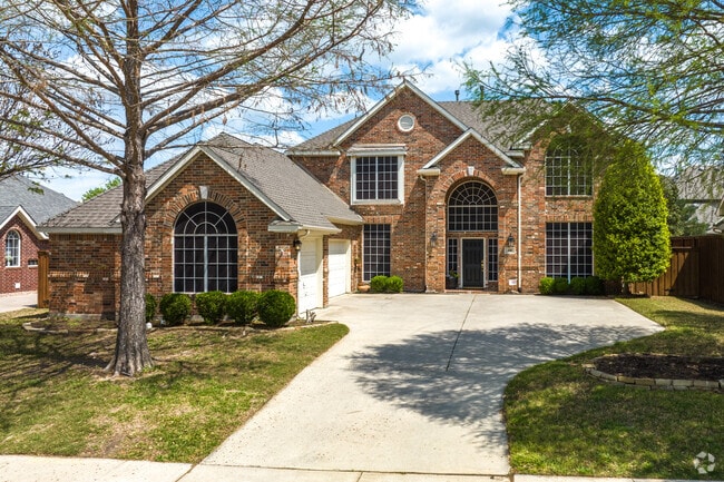 Two-story traditional homes with stone and brick exteriors are common throughout Trophy Club.