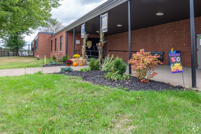 Plants, flowers, and signs dress up the front of Bethlehem Elementary School.