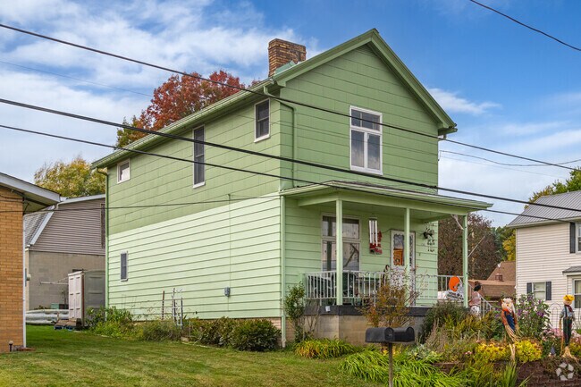 A colorful traditional Four Square home with a small covered front porch in West Mayfield.