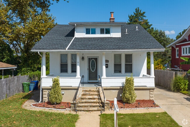 A large shaded front porch offers relief from summer heat on a classic bungalow in Christopher.