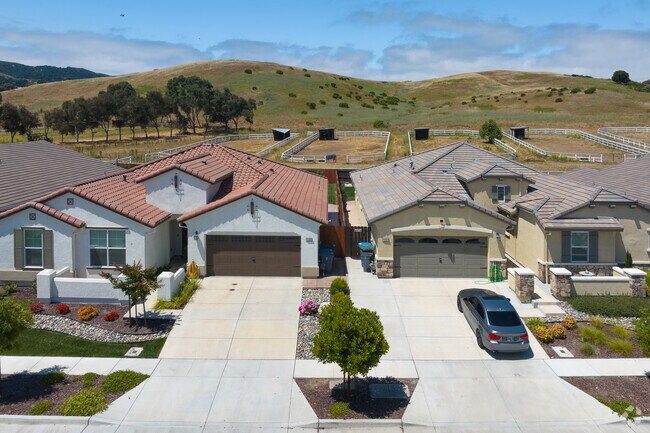 Spanish-inspired bungalows sit close to horse corrals and mountains in San Juan Bautista.