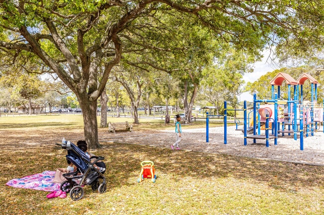 A family having a picnic near a playground at Okeeheelee Park.