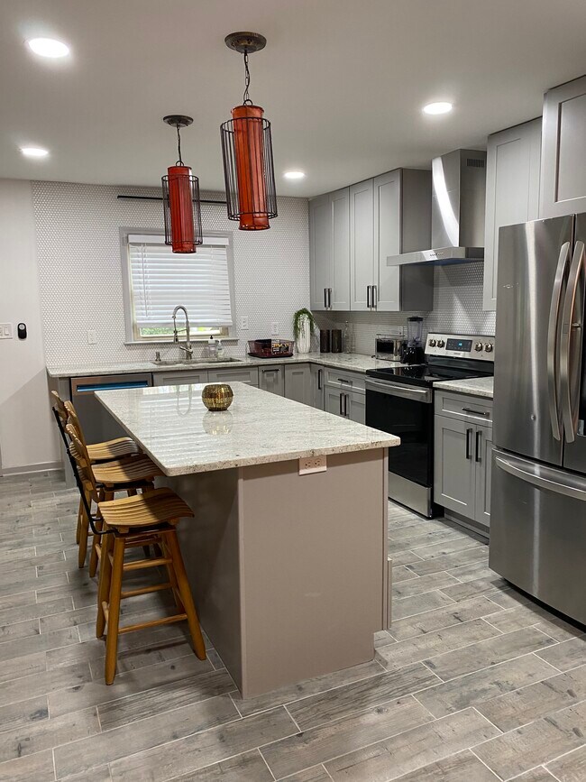 Chef-inspired kitchen featuring stainless steel appliances and clean, modern finished