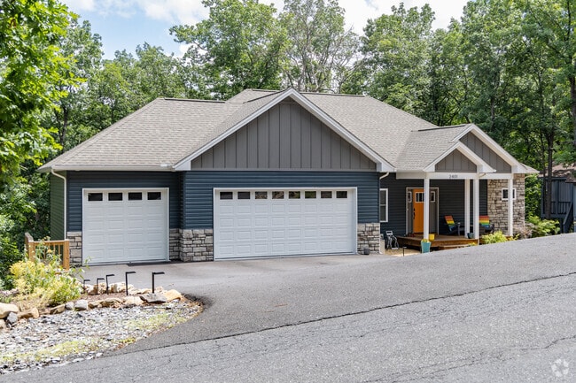 Newer single family homes with garages sit on hilltops in Massanutten.