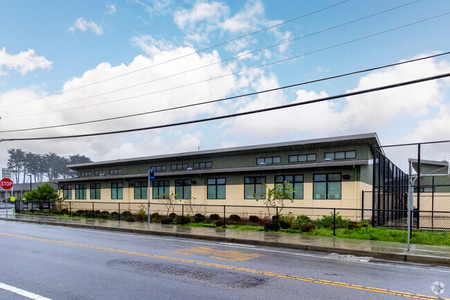 The campus of Pilarcitos Alternative High School includes modern buildings for students.