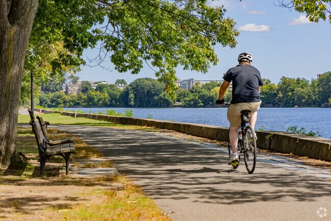 A cyclist cruises down the Vanderburg Esplanade alongside the Merrimack in Lowell.