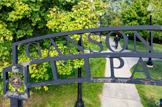 A walking path loops through Ganson Street Park and past some benches and a small playground.