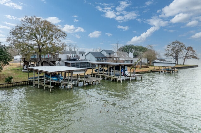 Lakefront houses in West Livingston feature private docks and boats for waterfront living.