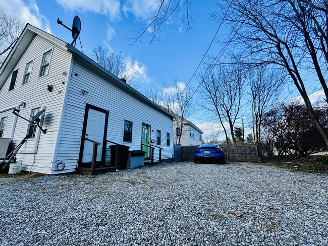 Front door and 4 full sized vehicle parking lot
