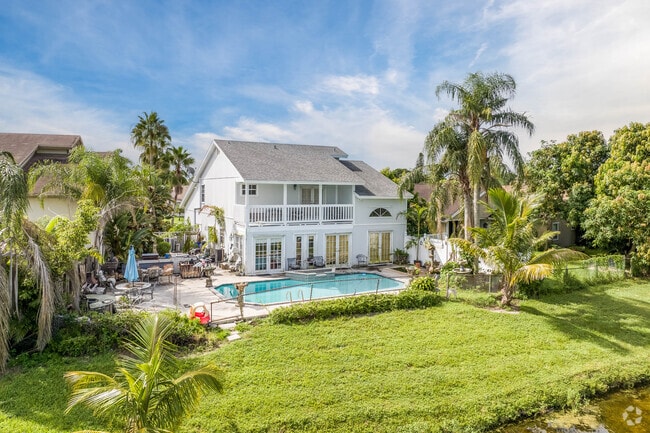 A two story side gabled home with a pool in Lakeside green.