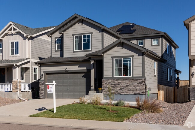 This Terrain craftsman-style home features a small yard and a two-car garage.