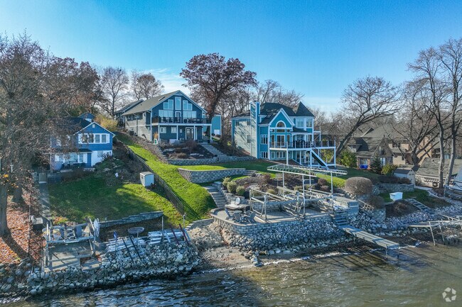 Row of large homes with balconies overlooking the water in East Johnsburg.