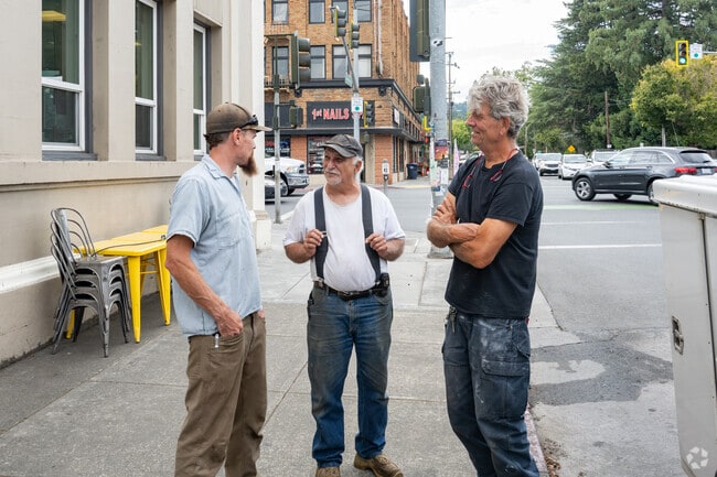 Local Willits friends share a laugh outside of Brickhouse Coffee on the corner of Main and Commercial Streets.