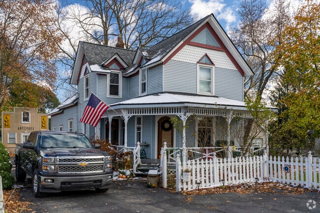 Victorian homes with fish-scale siding line Ortonville’s lanes.