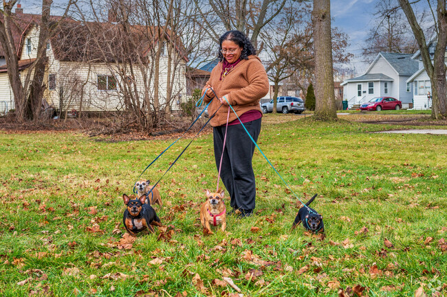 A woman enjoys a walk with her dogs in the Turner-Dodge neighborhood.