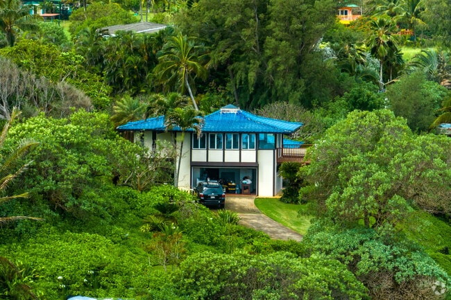 Colorful Spanish style homes are nestled in the hillside in Anahola.