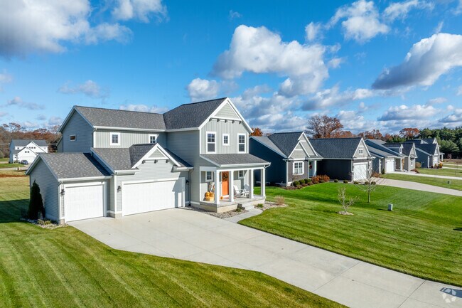 Newer Muskegon Township homes often add driveways and attached garages.
