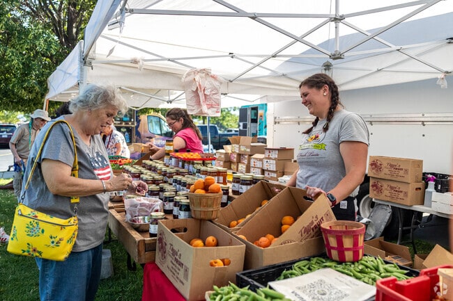 Locals buy fresh food at the Farmer’s Market at Centennial Park in Hunter.