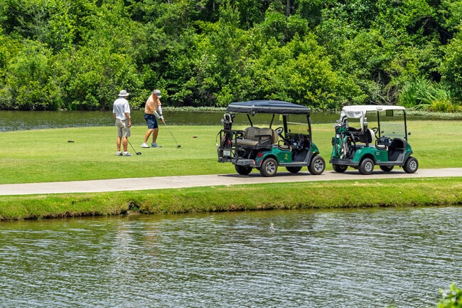 Golfers tee off by the water on Pinehurst's world-renowned championship courses.