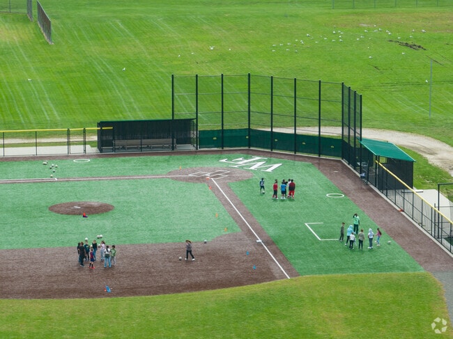 Kids on the large baseball field behind Tangier Smith Elementary School.