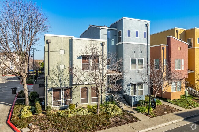 This modern style town home is multicolored and has 3-stories in Capital Village.