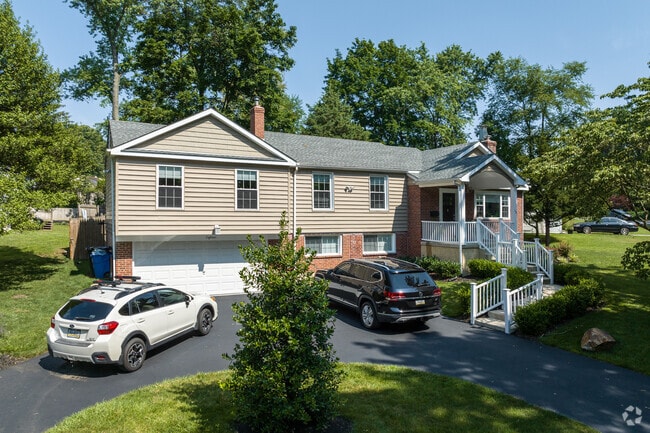 A split-level home sits on a shady corner in St David's.