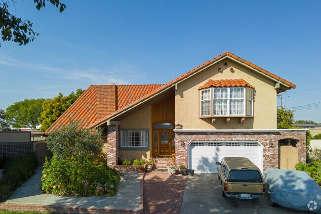 A split-level home has a traditional Spanish tile roof in Los Alamitos.