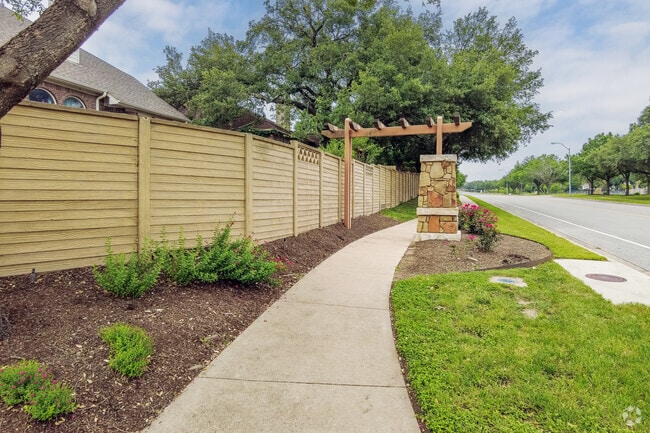 Well‑maintained sidewalks add walkability under mature shade trees.