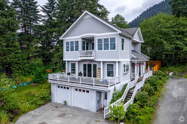 Large two-story homes line the mountainside, overlooking downtown Juneau.