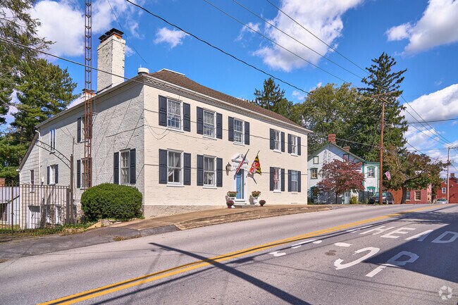 A large Colonial-Style home sits on a hill in central Leitersburg.