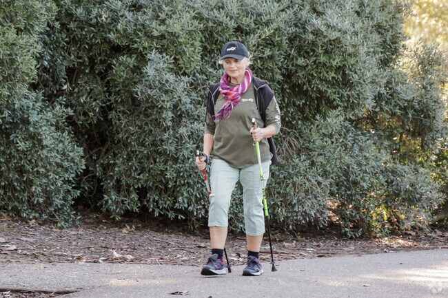 Tranquil trek Woman hiking through Arbolado Park, Northgate.