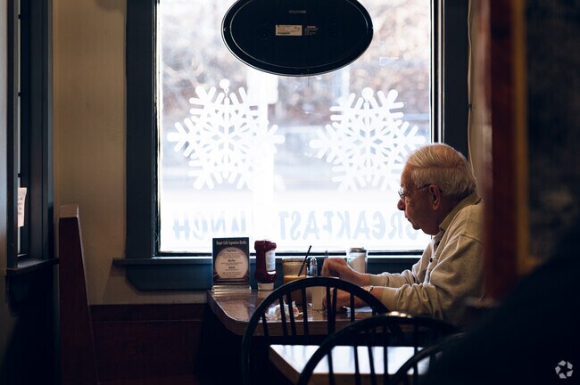 Local enjoys a peaceful breakfast downtown at coffee shop.
