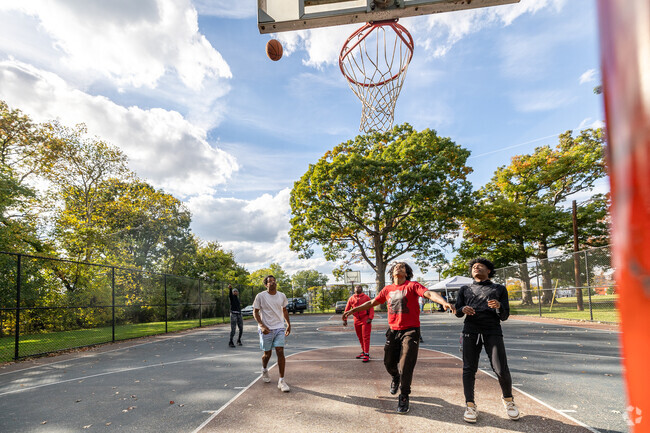 Students play basketball in the park across from Carver Vocational High School.
