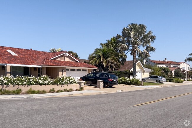 This colorful roffed Southeast Huntington Beach ranch home has skylights and a rose garden.