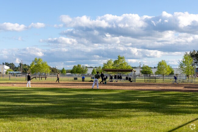 Kids play a game of baseball on the ballfield at Kronenwetter Municipal Park.